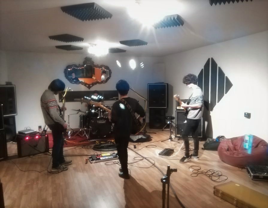 The Mouldy Cave Society in the recording studio, with Rafael Xavier on guitar and vocals, Joaquim Sousa on drums, Tiago Horta on bass and Jorge Araújo on guitar, during the recording sessions for Tea Time In A Mouldy Cave